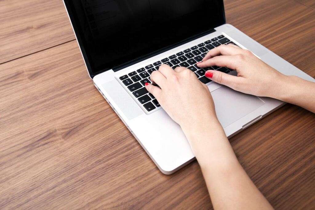 woman typing on laptop computer